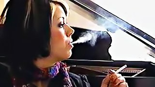 Girl in scarf smokes cigarette