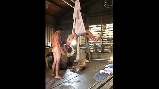 Sucking cock hanging from a meat hook