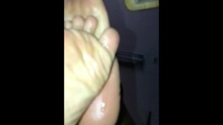 Thick ebony toes dripping oil in slow motion