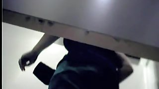 She loses down cloths and demonstrates ass in change room