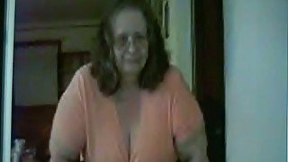 Slutty granny shows her big tits and smokes in front of a webcam