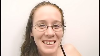 Nerdy girl in glasses gives a blowjob in an office