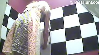 Blonde pees in a public bathroom