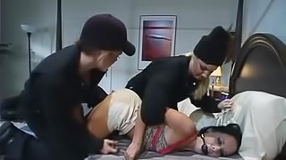 A brunette gets whipped and fucked by two dominant blondes