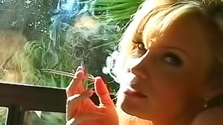 Blonde with big sexy tits smokes