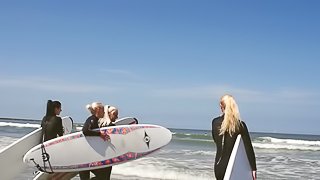 Four hot surfer girls eat pussy in the sand during a foursome