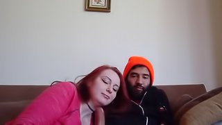 An amazing redhead sucking and rides her boyfriend on the couch