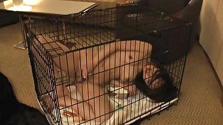 Submissive slut in a cage masturbates solo