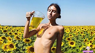 Fertility goddess caresses her pussy in a sunflower field