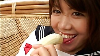 Cute and pretty teen babe playing with her banana and a hard cock and sticking it up her mouth
