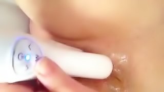 Amateur girl fingers her shaved crotch and fucks it with a dildo