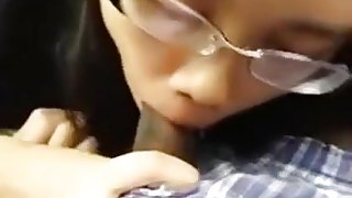 Nerdy asian girl with glasses sucks her black bf's cock in the car on a parking lot