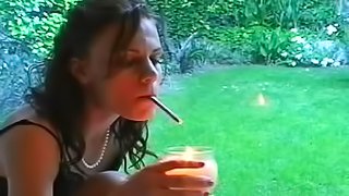 Stunning beauty is smoking a cigarette in a hot way
