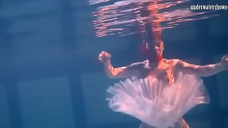 Sensual Russian redhead removes her clothes under the water