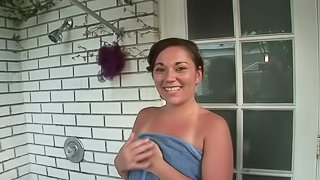 Tattooed brunette playing with her shaved pussy in the shower