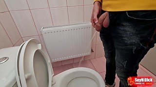 Uncircumcised cock pees on the station toilet