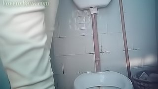 Hidden cam is filming sweet brunette pissing in the toilet