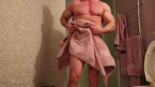 Fitness model dries himself off after shower