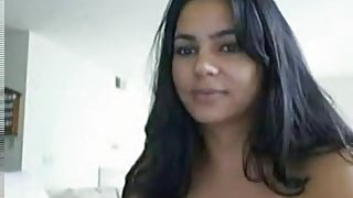 Dark haired hot latina girl plays with her pussy on the sofa