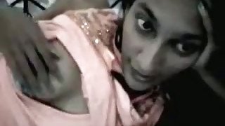 Lying on her bed straight haired slim Indian chick tries to show her tits