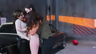 A threesome is done by the hood of the car with three hot ggirls