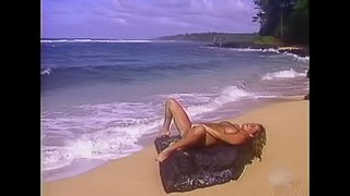 Huge tits jiggle while she masturbates on the beach