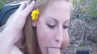 Flirtatious long haired blonde sucks a big cock outdoors