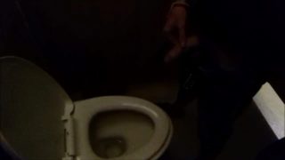 Guy pisses in a public toilet