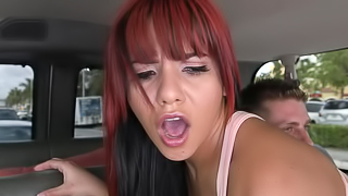 Redhead is in the back of a van, showing her love for a dick