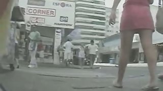 Cute bimbo in pink skirt caught on upskirt video on the street