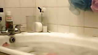 Young bimbo voyeured washing in the soaped bath
