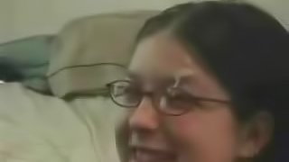 A nasty brunette gets a cumshot to her face and glasses
