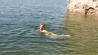 Cute youthful brunette hair disrobes by the water and goes slim dipping