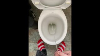 Pissing at home in red and white socks