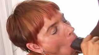 A mature white woman gets fucked and filled with cum by a black guy