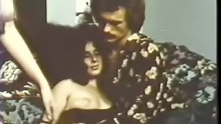 Cock-hungry brunette enjoying a hard one in a vintage porn clip