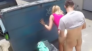 A blonde is pressed against the dumpster and she is fucked well
