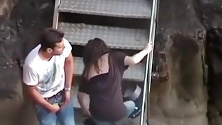 Voyeur captures a girl riding her bf on the stairs in public
