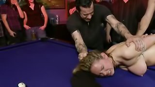 Nice blonde doing a good job at being a gang bang girl while tied up in a club on the pool table