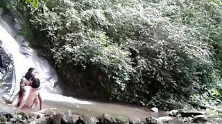 Latin couple makes a sextape near a waterfall in nature